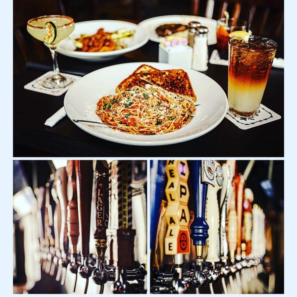 Spaghetti with garlic bread and cocktails on a table, with beer taps below.